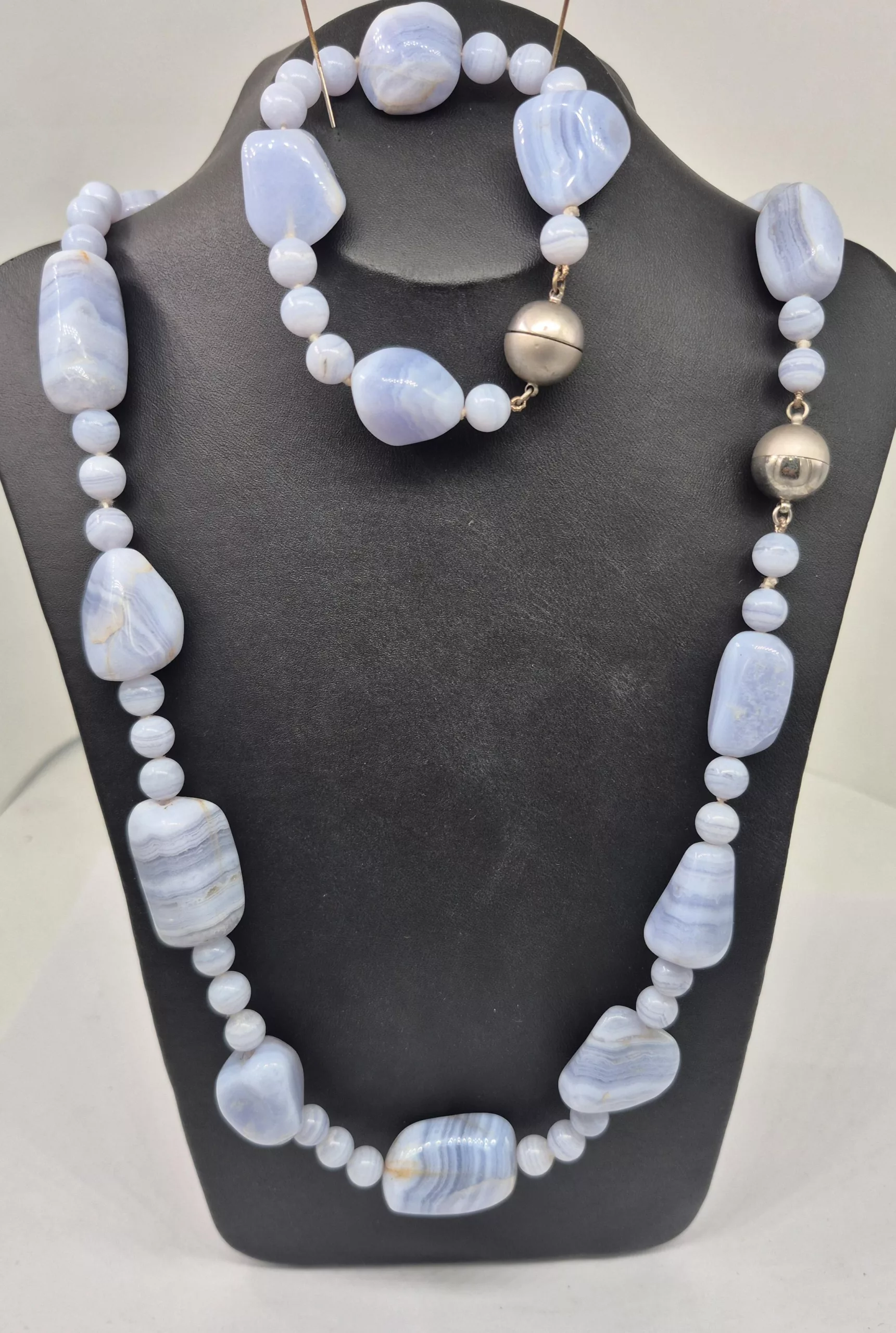 Close-up of a hand modeling a new custom diamond ring creation.