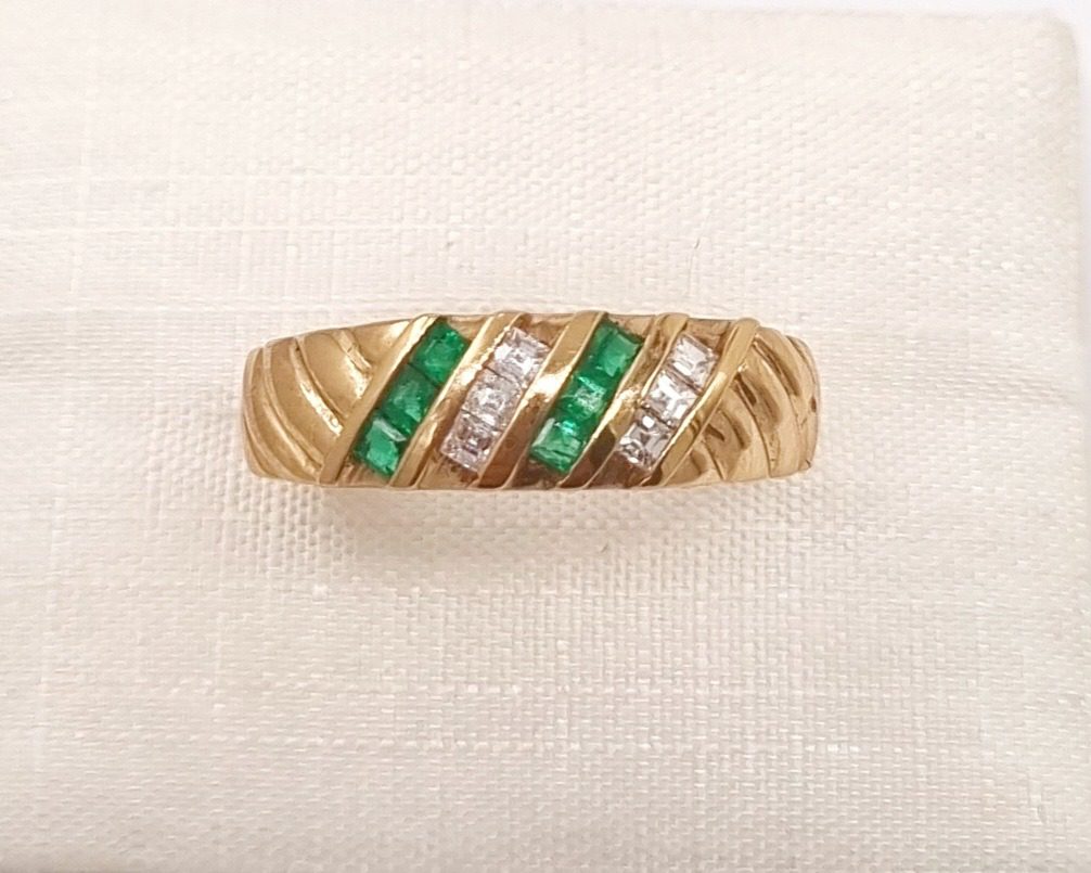 A couple holding hands, showing off a new luxury engagement ring.